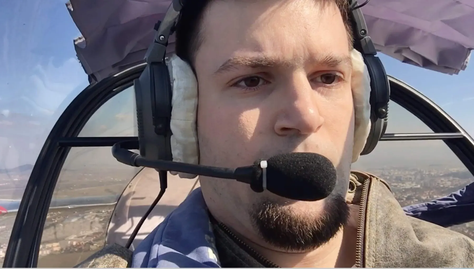 Tedy Necula with a headset in a small aircraft