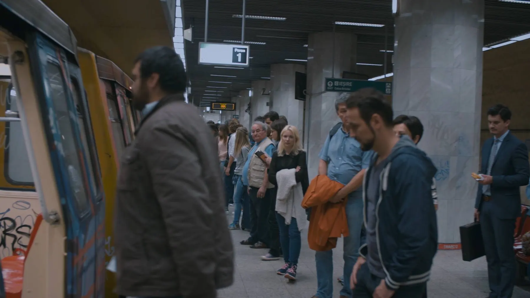 Still from Beside Me: passengers on a Bucharest subway platform